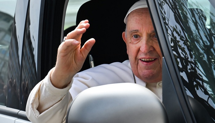 Pope Francis waves as he leaves the Gemelli hospital in Rome, after being discharged following treatment for bronchitis.— AFP/File