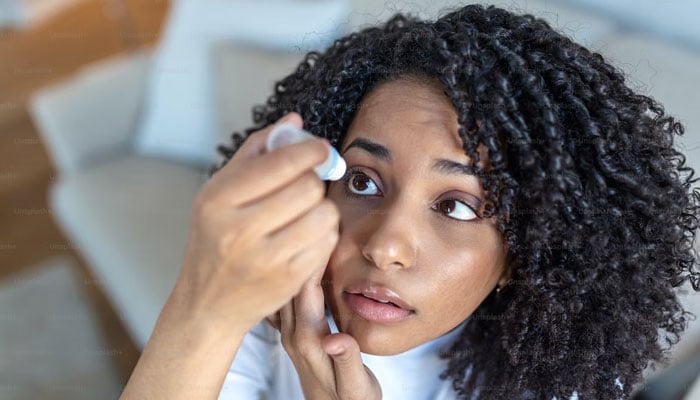 This representational picture shows a woman applying drops to er eyes. — Unsplash/File