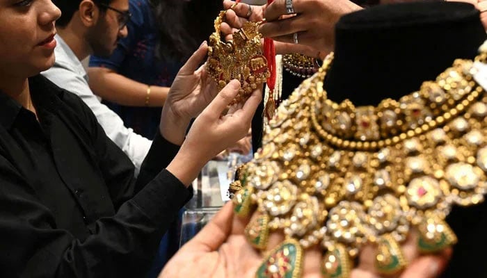 An undated image of a customer looking at a gold set in the market. — AFP/File