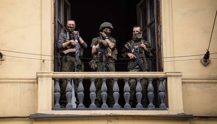 Members of Wagner group stand on the balcony of the circus building in the city of Rostov-on-Don, on June 24, 2023. — AFP