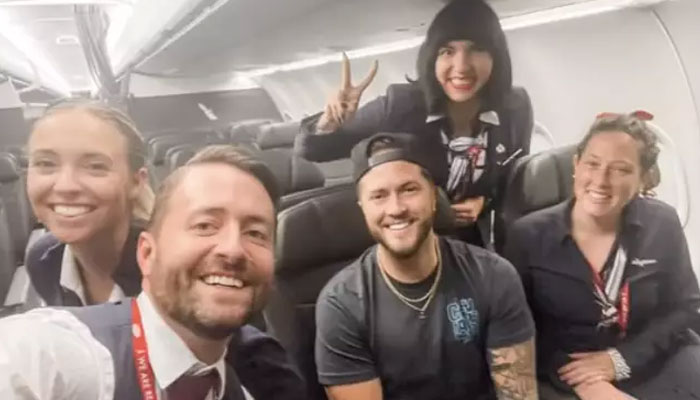 Phil Stringer (middle) with the flight crew he made friends with as the only passenger on his flight. — TikTok/Phil.Stringer