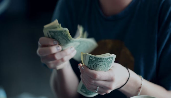 This representational picture shows a girl counting money. — Unsplash/File