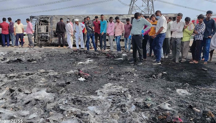 This picture shows a group of people at the crash site of the bus fire in India. — AFP/File