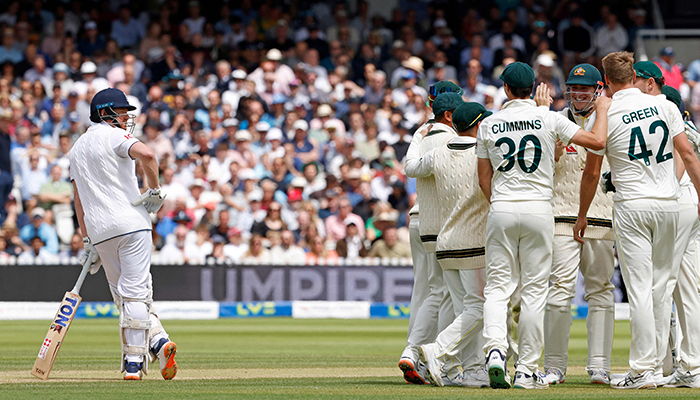 Englands Jonny Bairstow (L) reacts as Australia celebrate his wicket, following a review, on day five of the second Ashes cricket Test match between England and Australia at Lords cricket ground in London on July 2, 2023. — AFP