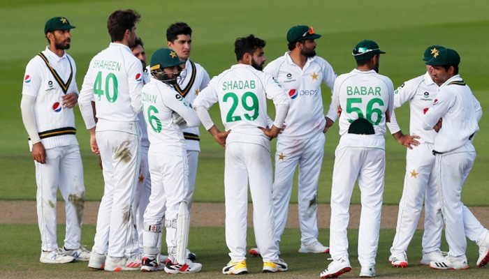 Pakistan squad await a decision on dismissal appeal during a Test match in this undated photo. — PCB/File