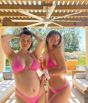 Kourtney Kardashian shows off baby bump in pink bikini