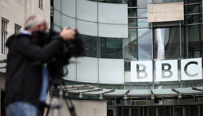 A member of the media works outside BBC Broadcasting House in central London on July 9, 2023. — AFP