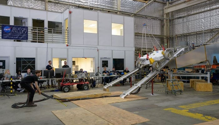 Antoine Tardy, VIPER rover egress driver, adjusts the cables that power and send commands to the VIPER test unit as engineers practice its exit/descent from the model Griffin lunar lander at Nasas Ames Research Center in Californias Silicon Valley. — Nasa/File