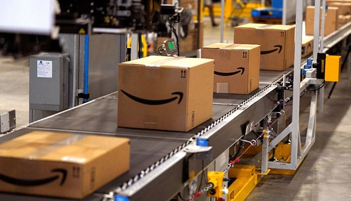 In this file photo taken on May 02, 2018, packed orders move down a conveyor belt at the Amazon fulfilment centre in Aurora, Colorado. — AFP