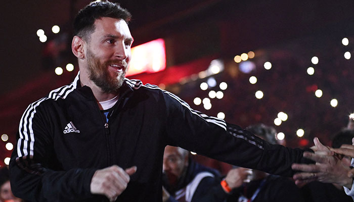 Argentine football player Lionel Messi greets fans during his entrance to the field before the start of Maximiliano Rodriguez´s farewell match at the Marcelo Bielsa stadium in Rosario, Argentina on January 24, 2023.—AFP