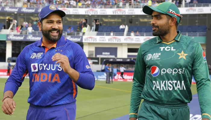 India captain Rohit Sharma (left) walks on the field with Pakistan skipper Babar Azam. — ACC