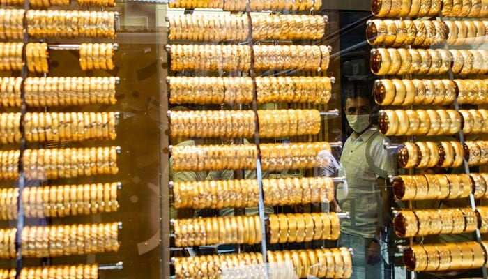 A man stands behind a gold shop window in Istanbul. — AFP/File