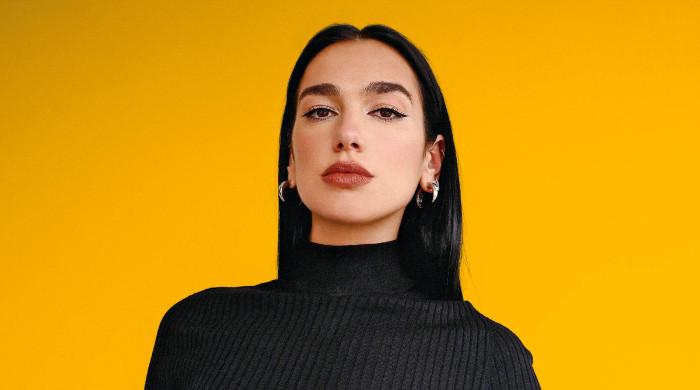 Dua Lipa puts on a leggy display in a black mini dress with matching jacket  and