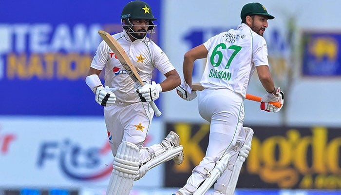 Pakistan´s Agha Salman (right) and Saud Shakeel run between the wickets during the second day of the first cricket Test match between Sri Lanka and Pakistan at the Galle International Cricket Stadium in Galle on July 17, 2023. — AFP