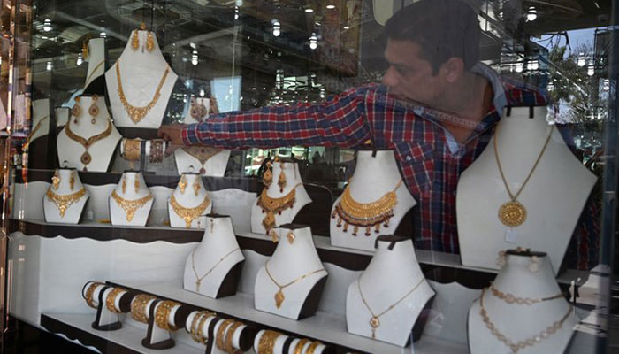 A shopkeeper sets gold jewellery at his store in Rawalpindi in this undated file photo. — AFP/File