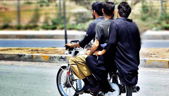 Three people commuting on a bike. — APP/File