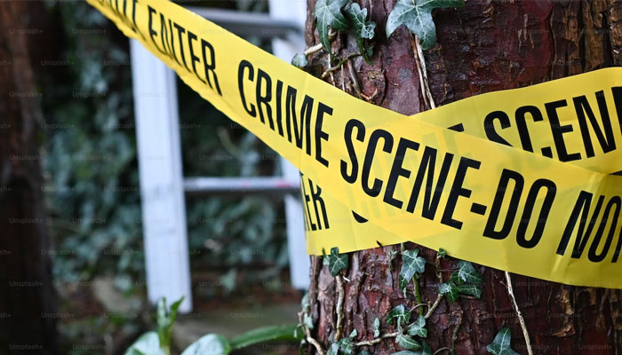 This representational picture shows a crime scene tape wrapped around a tree. — Unsplash/File