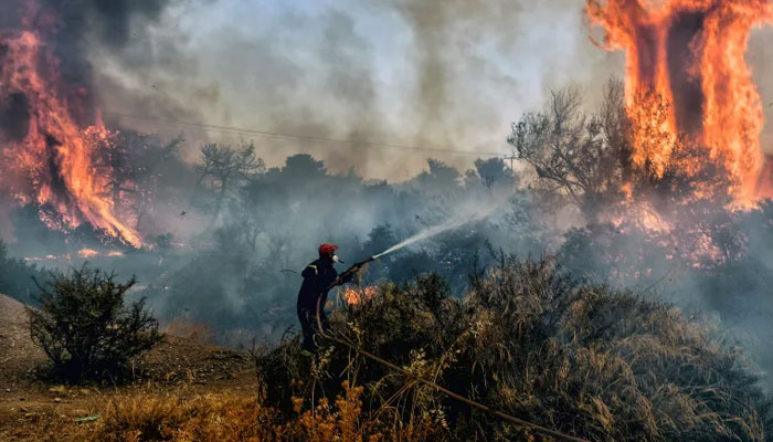 This representational picture shows a firefighter as he douses flames on a wildfire at Panorama settlement near Agioi Theodoroi, some 70km (43 miles) west of Athens. — AFP/File