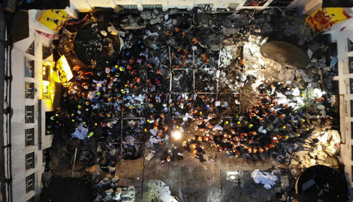 An aerial view of rescue workers and locals within during the rescue operation inside the destroyed facility. — Twitter/@PDChina