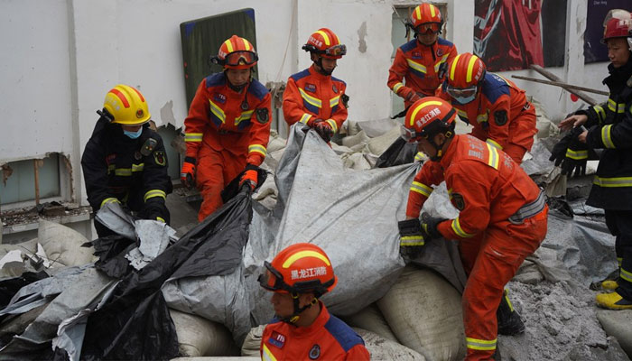 Rescue people conducting operations, searching for survivors from the rubble after the roof of a gymnasium in the province of Heilongjiang collapsed on July 23, 2023. — Twitter/XHNews