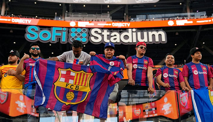 Fans attend the pre-season friendly match between Arsenal and Barcelona at SoFi Stadium on July 26, 2023 in Inglewood, California.—AFP