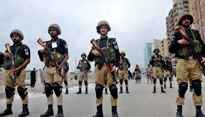 Security personnel standing on high alert during the main procession of 9th Muharram observing Youm-e-Ashur at MA Jinnah Road on July 28, 2023. — APP