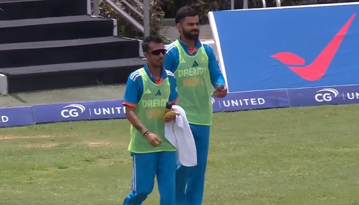 Top Indian batter Virat Kohli brings water and refreshments amid match against West Indies in this still taken from a video. — Twitter/@AdityaSingh5143