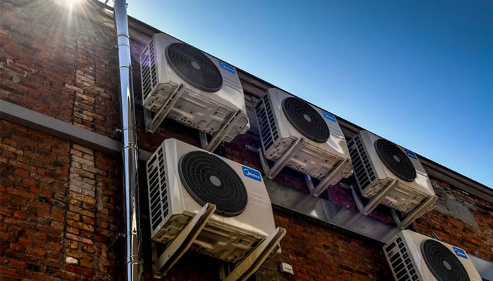 This representational picture shows several outers of air conditioners attached to buildings wall. — AFP/File