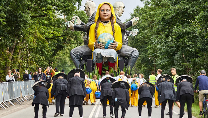 A giant doll representing climate activist Greta Thunberg in a procession at a music festival in Denmark. AFP/File