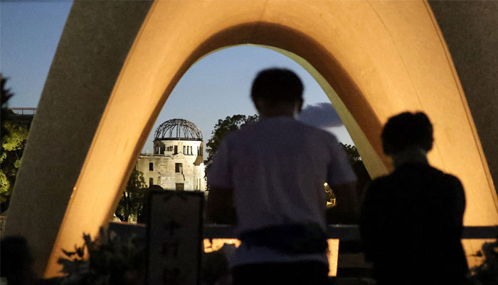 People visit the cenotaph for the atomic bomb victims before sunrise at the Peace Memorial Park in Hiroshima on August 6, 2023, to mark the 78th anniversary of the world´s first atomic bomb attack. — AFP