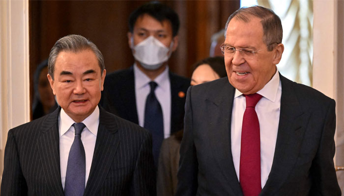 Russia´s Foreign Minister Sergei Lavrov and China´s Director of the Office of the Central Foreign Affairs Commission Wang Yi enter a hall during a meeting in Moscow on February 22, 2023. — AFP/File