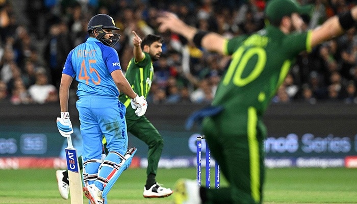 Pakistani bowlers Haris Rauf (centre) and Shaheen Shah Afridi (right) react to dismissal of Indian skipper Rohit Sharma (left) in a match at T20 World Cup 2022. — AFP/File