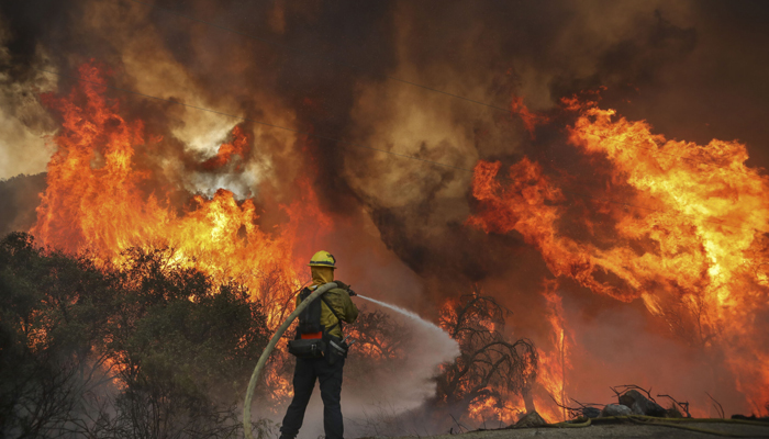 San Miguel County Firefighters battle a brush fire along Japatul Road during the Valley Fire in Jamul, California, on September 6, 2020. — AFP