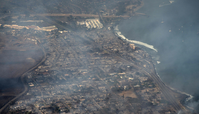 This photo shows an aerial view of smoke rising above as a wildfire burns in Lahaina, Hawaii, on August 9, 2023. — AFP