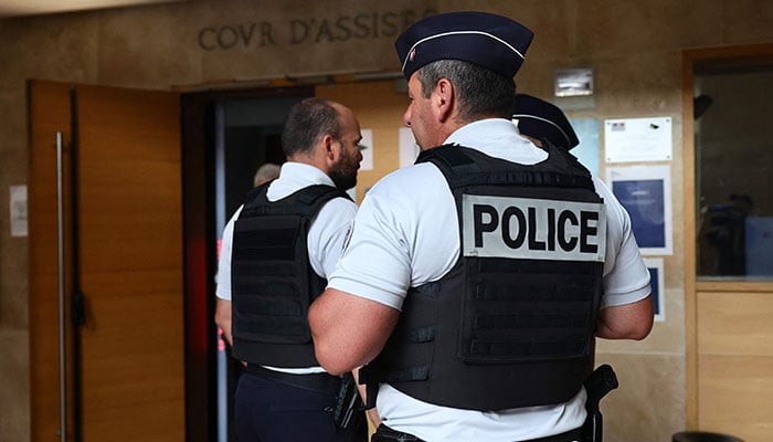 French police officers stand at the entrance of the Courtroom in Aix-en-Provence on August 3, 2023. — AFP/File