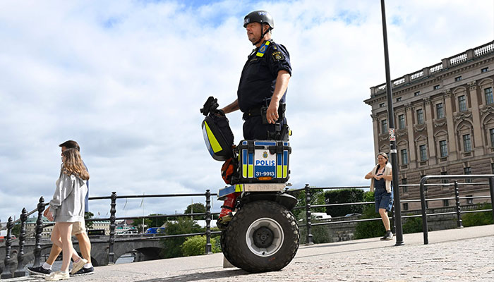 A police officer on a Segway patrol at Sweden´s parliament Riksdagen as the terror threat level in Sweden was raised to four on a five-point scale on August 17, 2023, following recent Quran burnings.—AFP