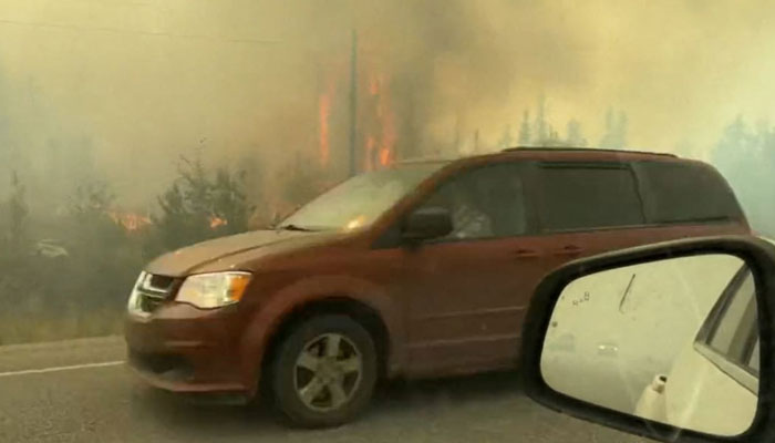 A video screengrab shows vehicles on the freeway as people evacuate from Yellowknife on 16 August.  AFP