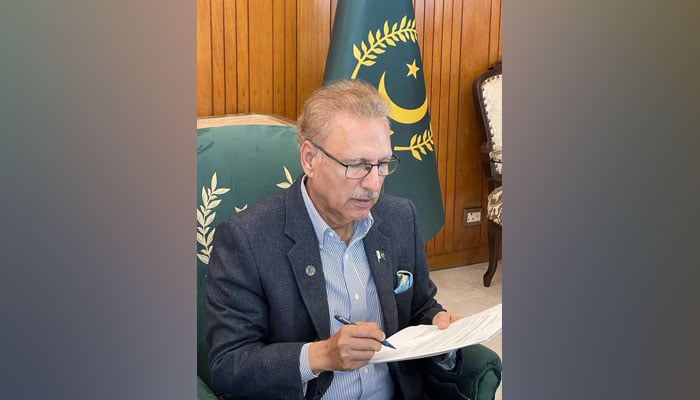 President Arif Alvi signing a document in this undated picture. —  President House