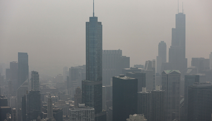 Chicagos skyline is seen from the 360 Chicago Observation Deck of the John Hancock Building with heavy smoke from the Canadian wildfires blanketing the city, on June 27, 2023, in Chicago, Illinois. — AFP