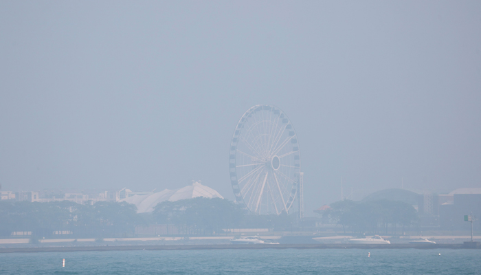 Wildfire smoke covers the Ferris wheel on Navy Pier on June 28, 2023, in Chicago, Illinois. — AFP