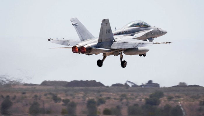 The image shows US F/A-18 Hornet military aircraft. — AFP