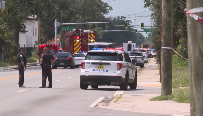 Police officers and vehicles are standing on the road after a mass shooting at Dollar General store in Jacksonville, Florida on August 26, 2023. — Screengrab/TouTube/First Coast News