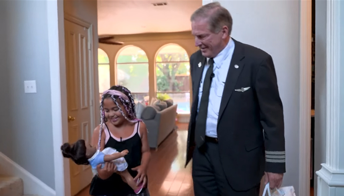 Valentina Dominguez, 9, can be seen happy after he doll was returned by American Airlines James Danen (right) from Tokyo to her home in Texas on August 21, 2023. — Screengrab/YouTube/KCEN News