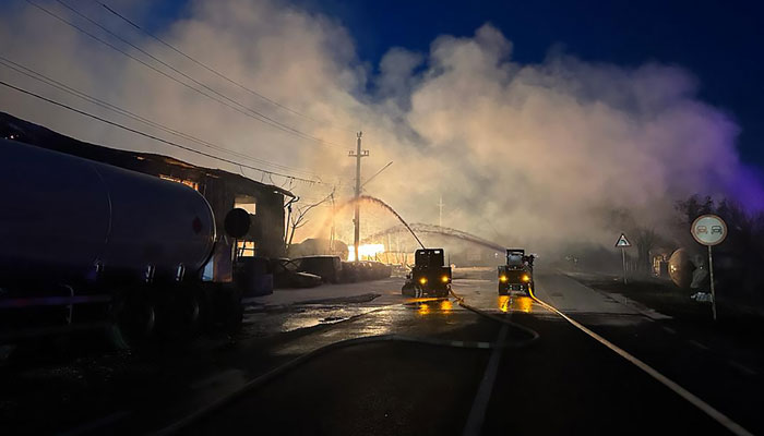 Robots spraying water to extinguish a fire caused by an explosion at an LPG station in Crevedia, Romania on August 26, 2023. — AFP