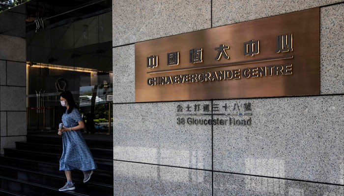 (FILES) A woman leaves the China Evergrande Centre in Hong Kong on July 28, 2022. Shares in troubled Chinese property giant Evergrande plummeted more than 80 percent in Hong Kong on August 28, 2023 morning after the lifting of a 17-month trading suspension.—AFP