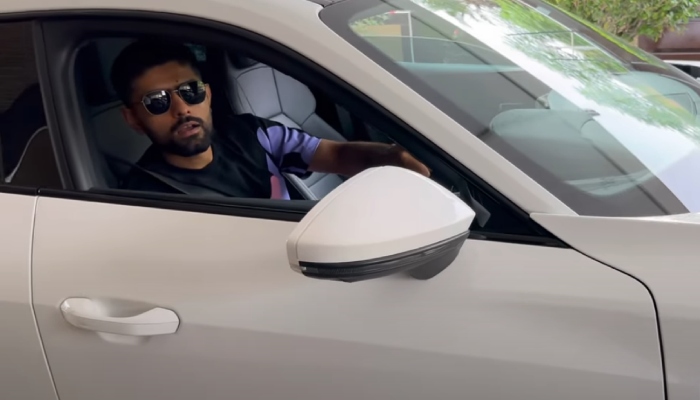 Pakistan skipper Babar Azam sitting in his new car in this screengrab taken from a video. — YouTube/