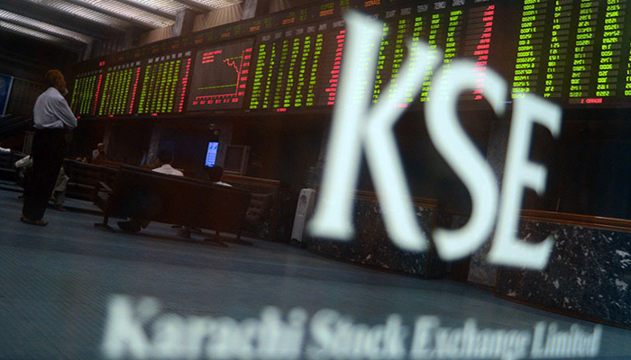 In this file photo, Pakistani stockbrokers watch the latest share prices on a digital board during a trading session at the Karachi Stock Exchange (KSE). — AFP/File