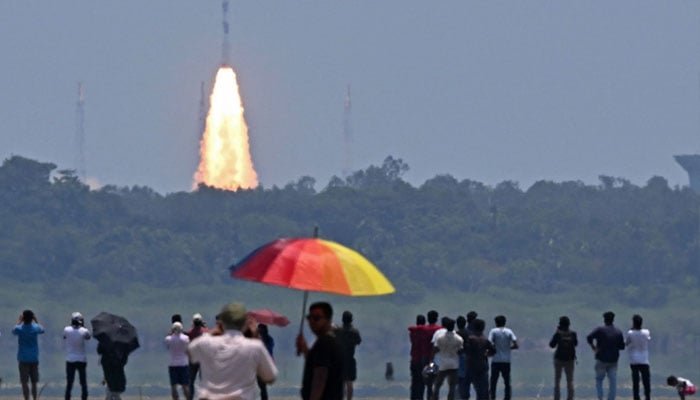 People watch as the PSLV XL rocket carrying the Aditya-L1 spacecraft, the first space-based Indian observatory to study the Sun, is launched from the Satish Dhawan Space Centre in Sriharikota on September 02, 2023.—AFP