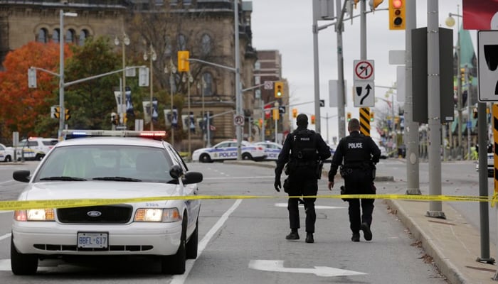 Ottawa police officers walk near the National War Memorial where a soldier was shot just blocks away from Parliament Hill in Ottawa, Canada. — AFP/File