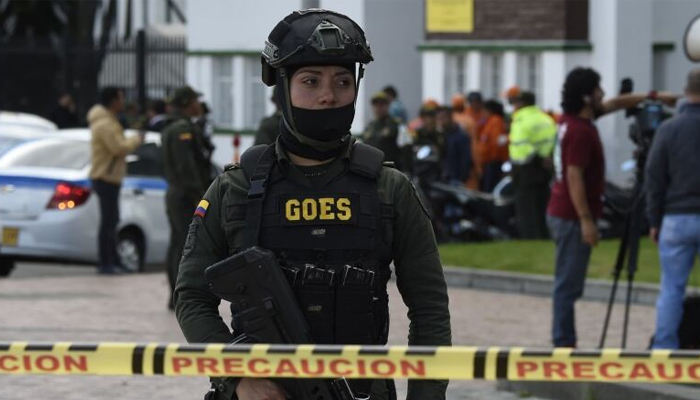 Security forces work at the site of a car bomb attack on the campus of a police cadet training school in Bogota, Colombia. — AFP/File